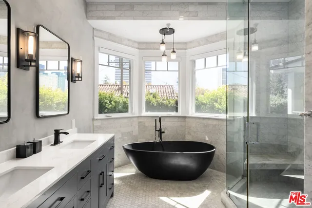 a living room with a large window and chandelier