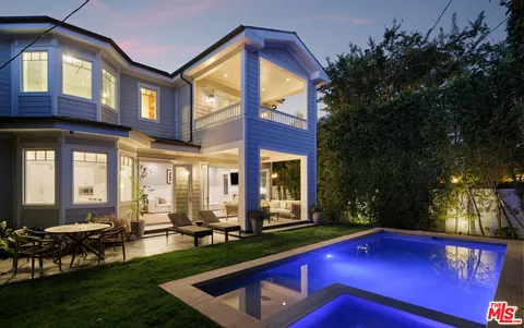 a view of an house with swimming pool and sitting area