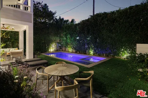 a view of a chairs and table in backyard
