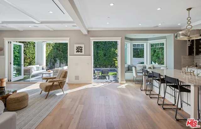 a living room with furniture and large windows