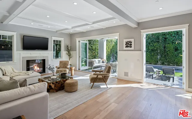 a living room with furniture fireplace and a large window