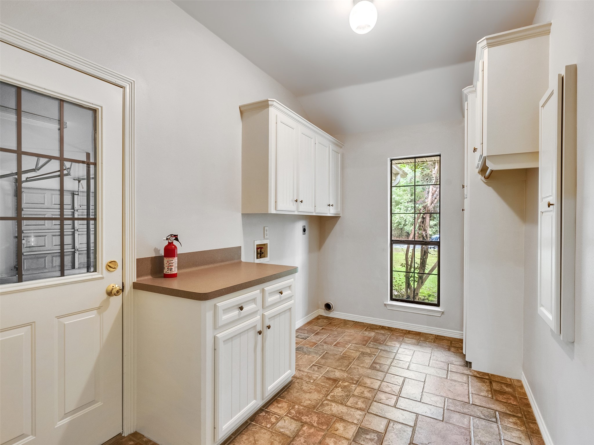195 Coral Gables Trinity, TX 75862 - Photo 15 of 50 a kitchen that has a lot of white cabinets and a window