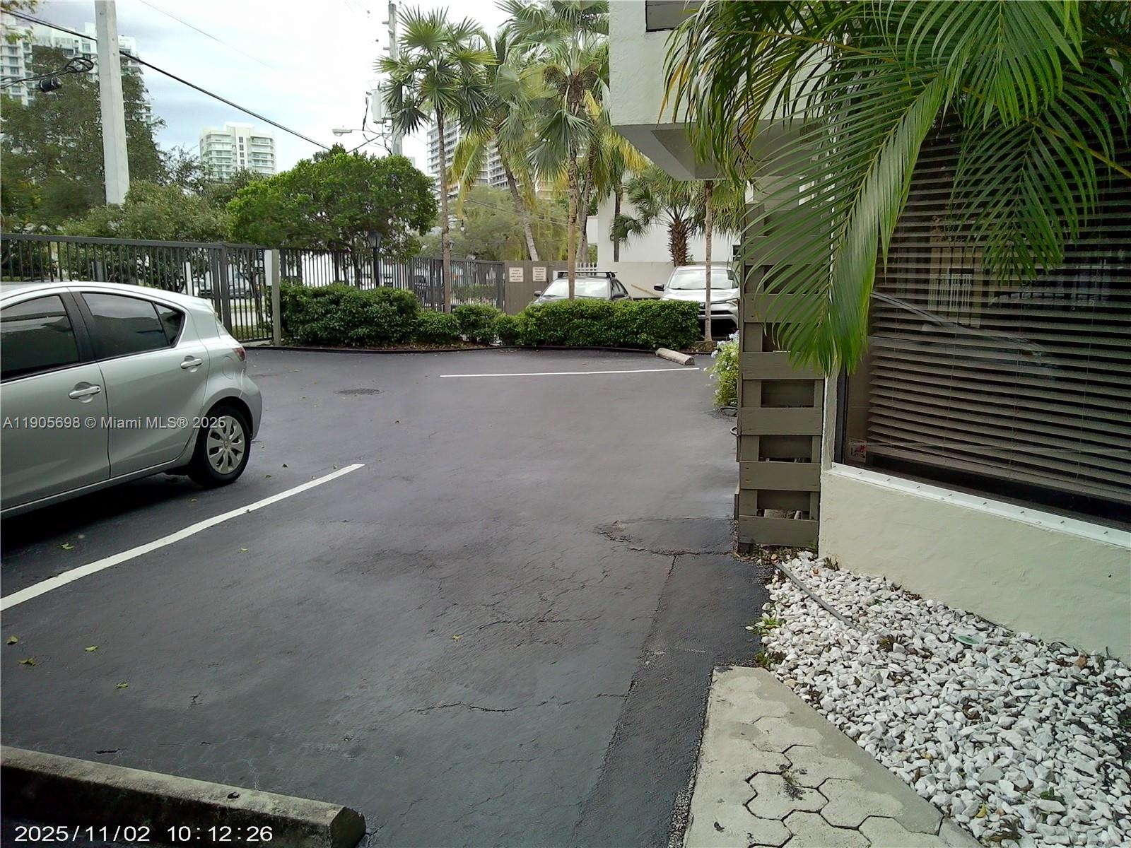 3036 Southwest 27th Avenue, Unit 5 Miami, FL 33133 - Photo 19 of 23 a view of a street with a cars park side of a road