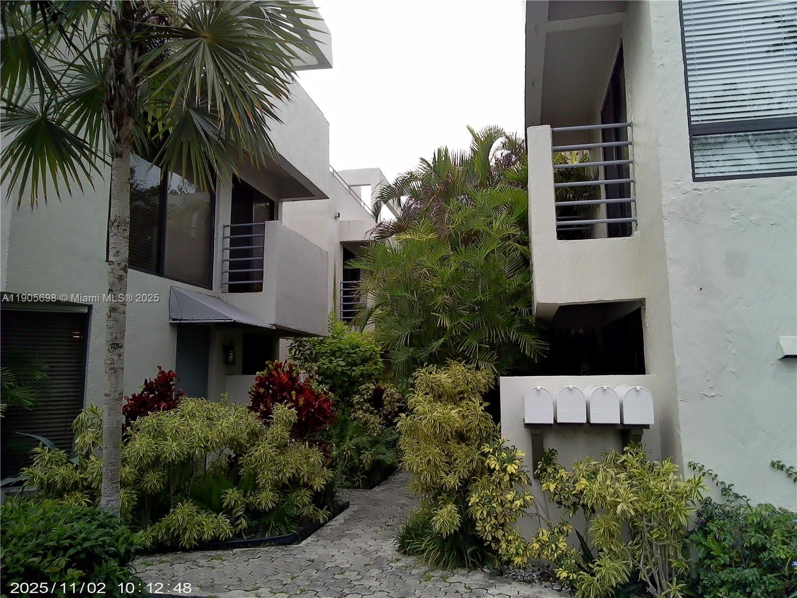 3036 Southwest 27th Avenue, Unit 5 Miami, FL 33133 - Photo 21 of 23 a view of a house with a house and a small yard