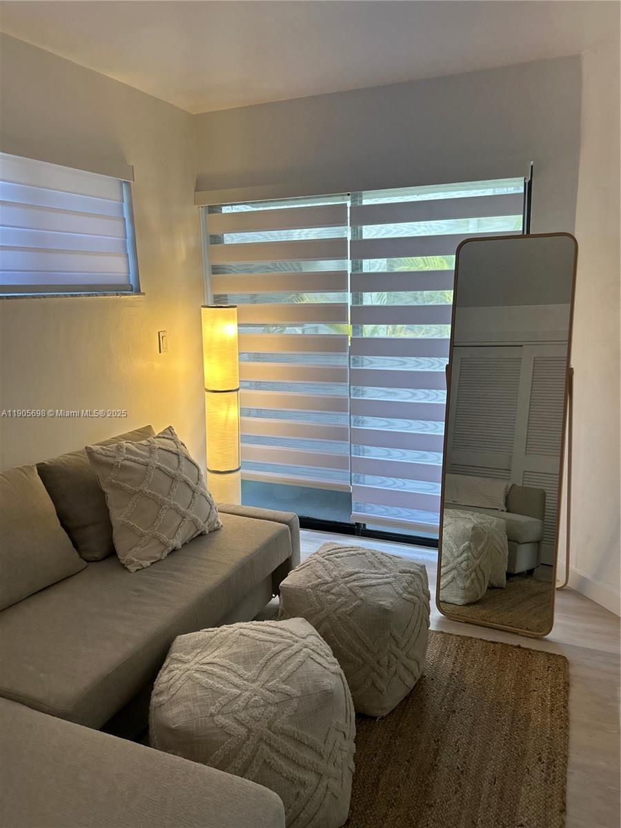 3036 Southwest 27th Avenue, Unit 5 Miami, FL 33133 - Photo 9 of 23 a living room with furniture and a window