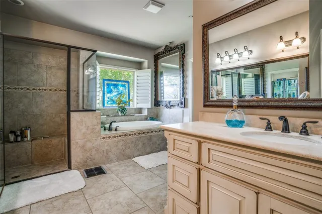 a spacious bathroom with a sink a large mirror and a shower