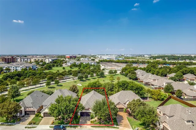 an aerial view of a house with a yard