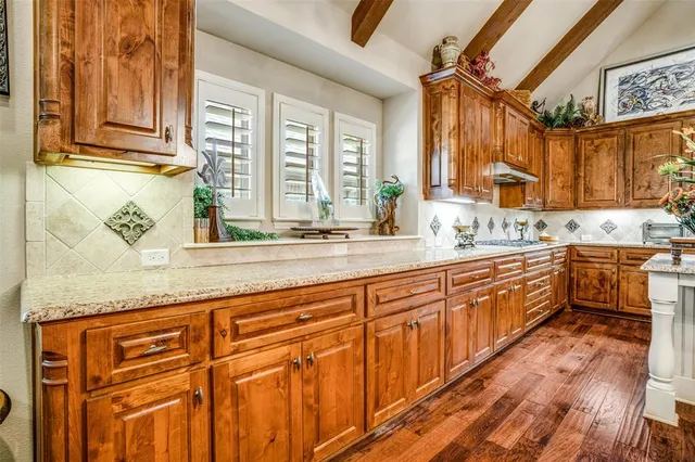 a view of a dining room with furniture a chandelier and wooden floor
