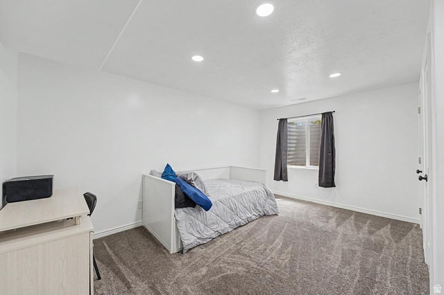 1692 South Windemere Road Santaquin, UT 84655 - Photo 15 of 23 Room featuring recessed lighting, a window with horizontal blinds and dark drapery, light gray wall-to-wall carpeting, and white painted walls