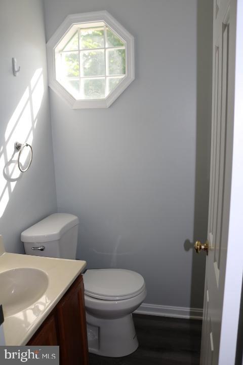 7313 Stream Way Springfield, VA 22152 - Photo 13 of 28 a bathroom with a sink a toilet and a window