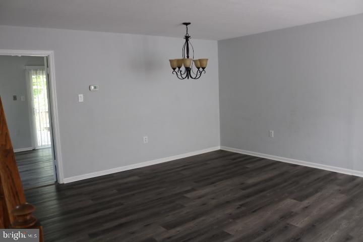 7313 Stream Way Springfield, VA 22152 - Photo 2 of 28 a view of a room with wooden floor and white walls