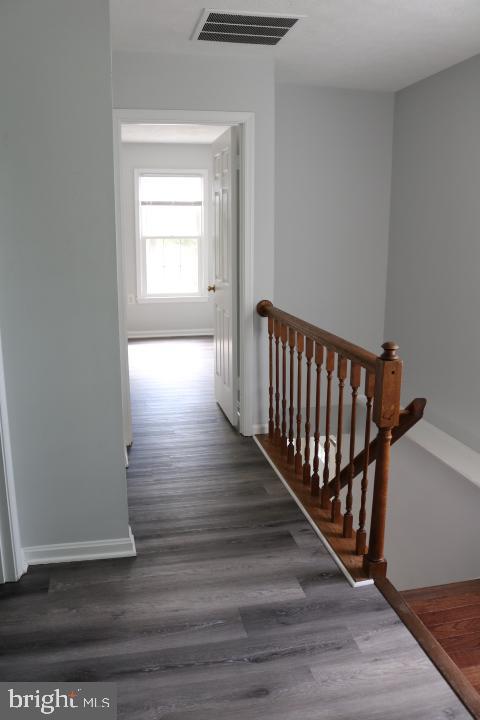 7313 Stream Way Springfield, VA 22152 - Photo 22 of 28 a view of a hallway with wooden floor and stairs