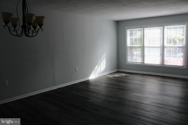 7313 Stream Way Springfield, VA 22152 - Photo 3 of 28 an empty room with wooden floor and windows