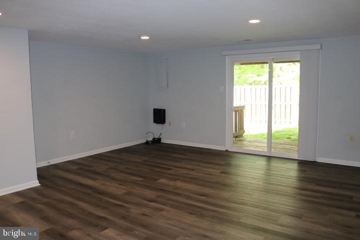 7313 Stream Way Springfield, VA 22152 - Photo 8 of 28 a view of empty room with wooden floor and fan