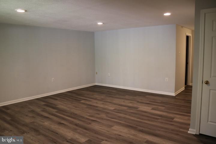 7313 Stream Way Springfield, VA 22152 - Photo 9 of 28 a view of an empty room with wooden floor and closet