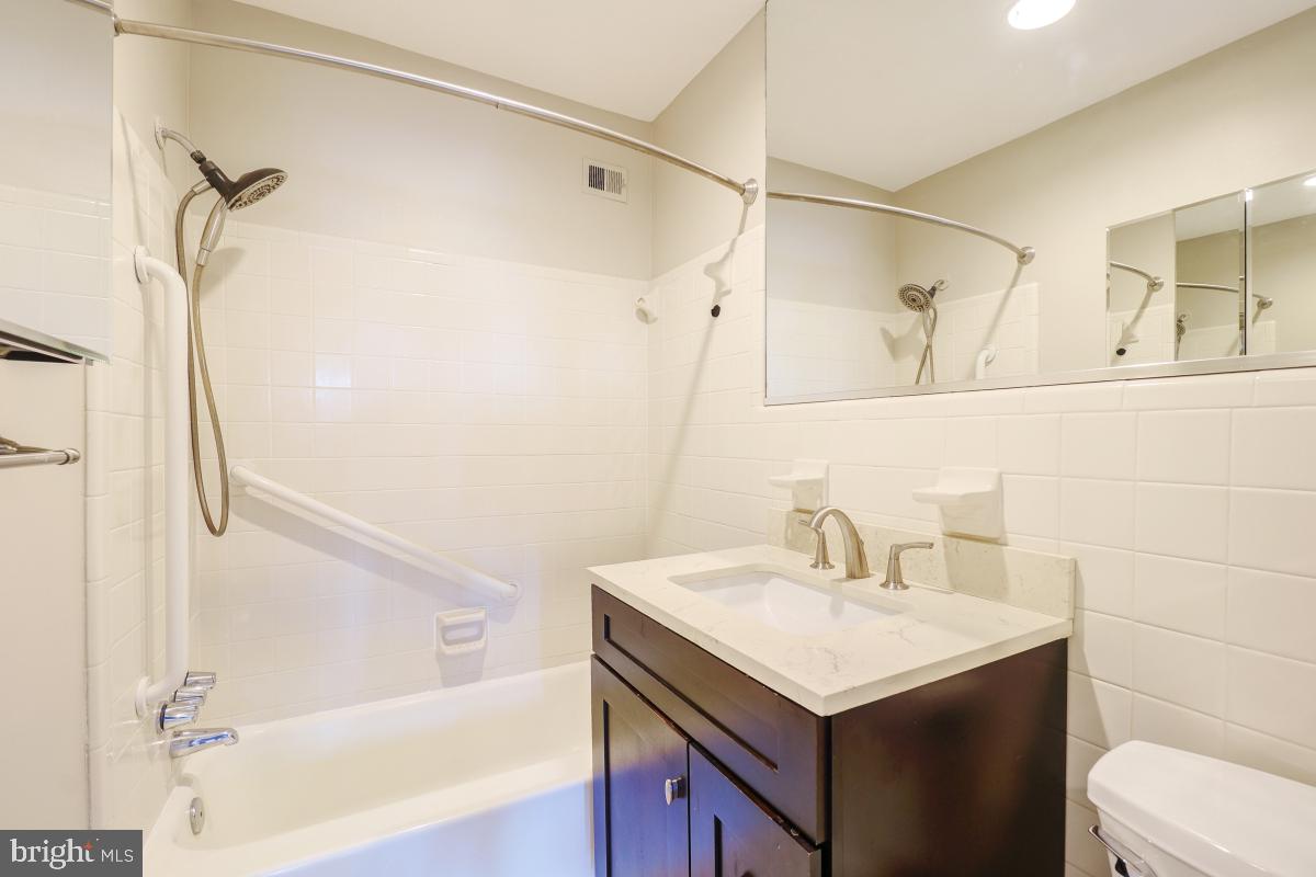 53 Skyhill Road, Unit 204 Alexandria, VA 22314 - Photo 23 of 26 a bathroom with a sink and a mirror
