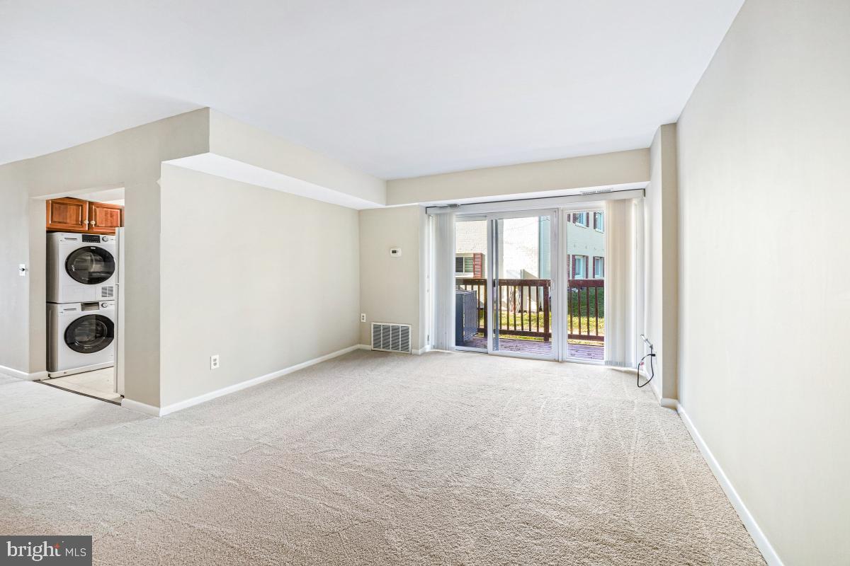 53 Skyhill Road, Unit 204 Alexandria, VA 22314 - Photo 7 of 26 an empty room with windows and fireplace