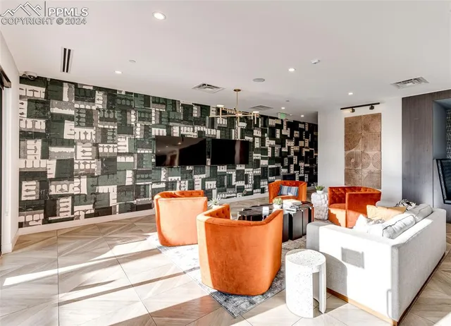 a living room with furniture and view of kitchen