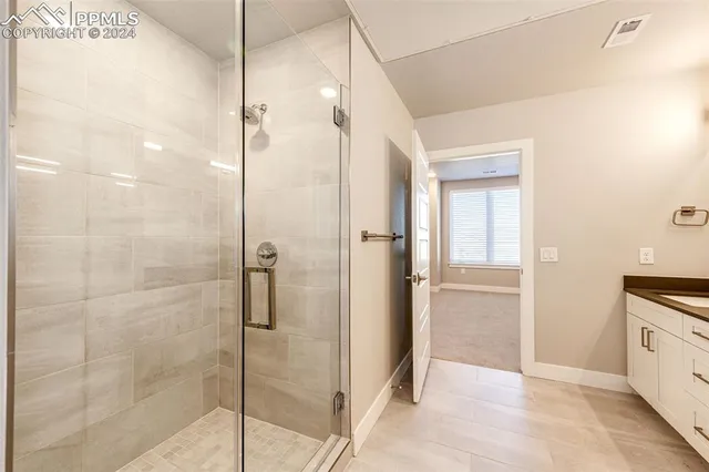 a bathroom with a granite countertop sink a toilet and bathtub