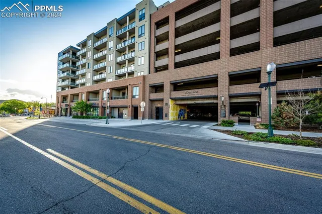 a view of house with yard and large trees