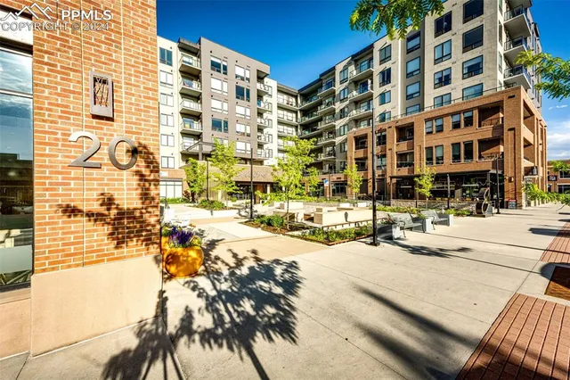 a living room with patio furniture and a view of kitchen