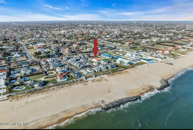 an aerial view of a house with a ocean view