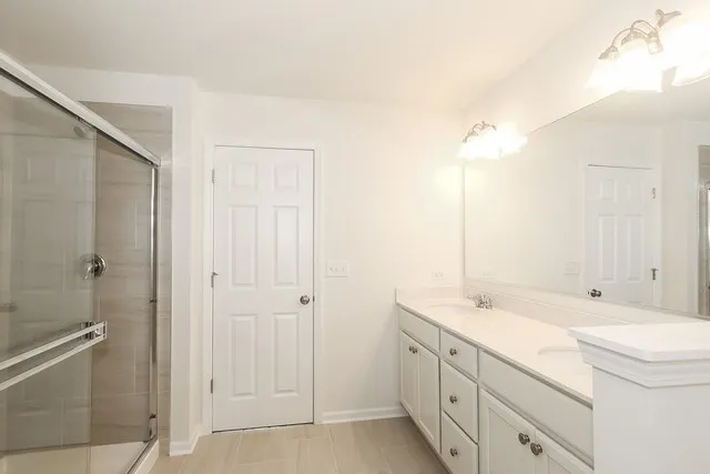 a bathroom with a double vanity sink and mirror