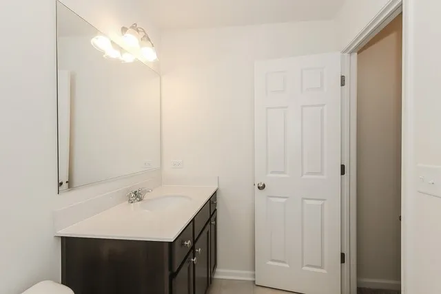 a bathroom with a sink vanity and a mirror