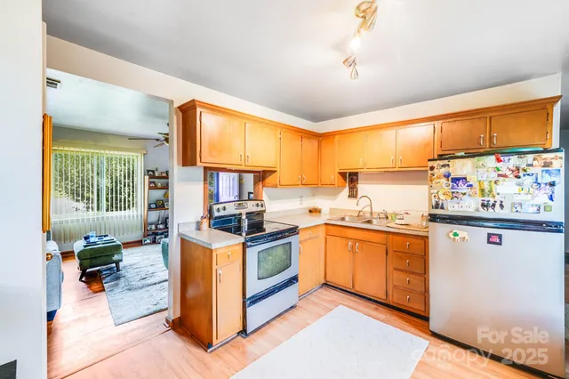 a kitchen with stainless steel appliances granite countertop a stove and a sink