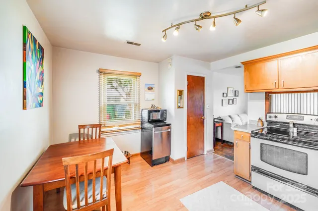 a kitchen with stainless steel appliances granite countertop a stove and a refrigerator