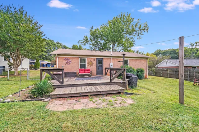 a view of a house with a yard patio and swimming pool