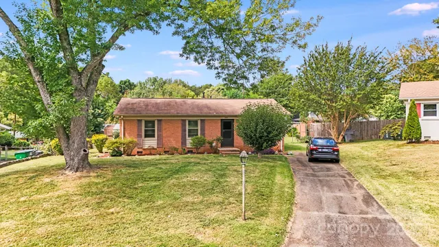 a view of a house with swimming pool and a yard