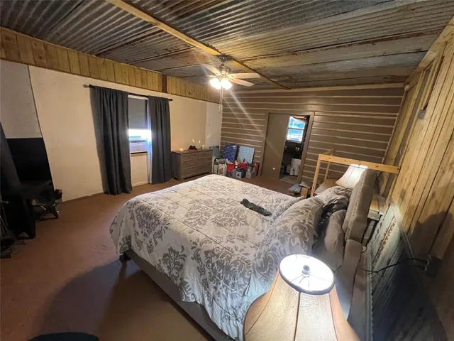 a bed sitting in a room next to a larger window