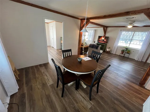 a view of a dining room with furniture and window