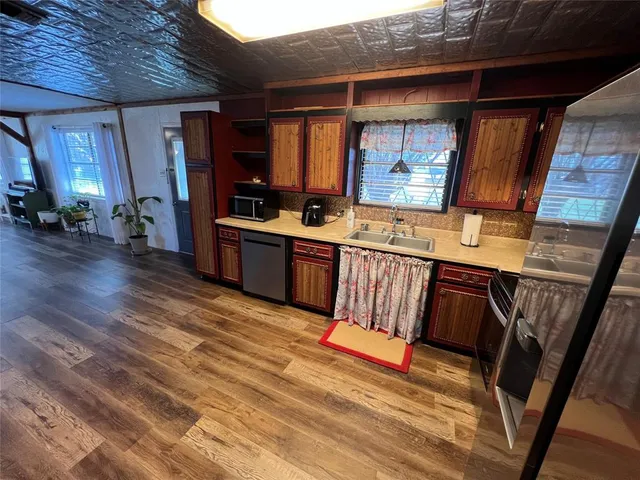 a view of kitchen with sink window and stainless steel appliances