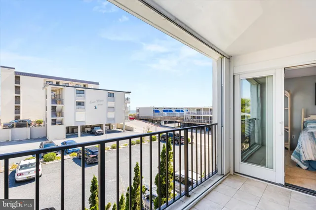 a bedroom with a bed and a lamp next to a window