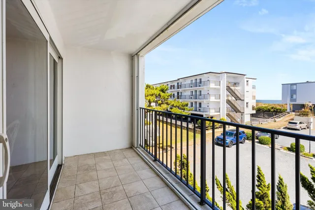 a view of a bedroom with wooden floor & fence