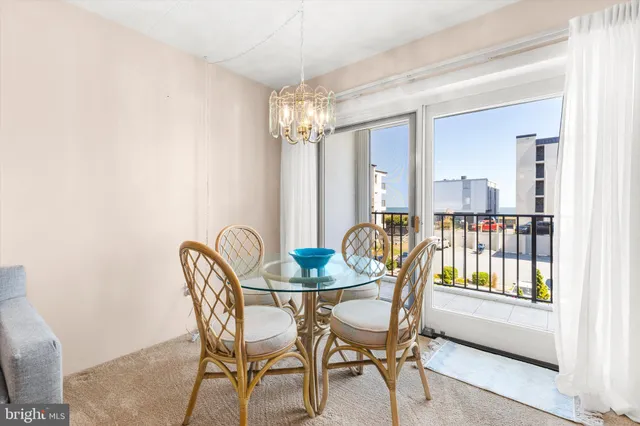 a living room with furniture a flat screen tv and large window