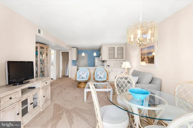 a living room with furniture a table and chair