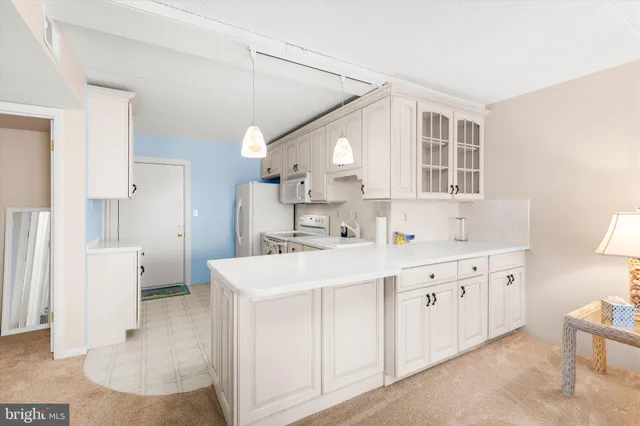 a kitchen with cabinets and window