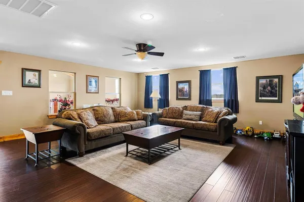 a living room with furniture and wooden floor