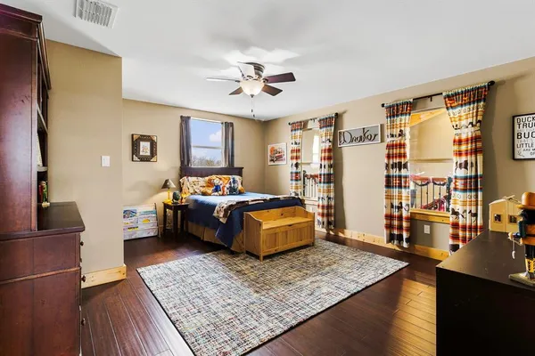 a bedroom with a bed couch and a window