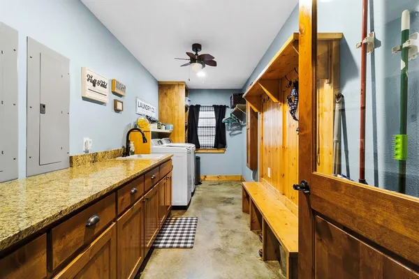 a bathroom with a granite countertop sink and a large mirror