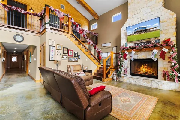 a living room with furniture a flat screen tv and a fireplace
