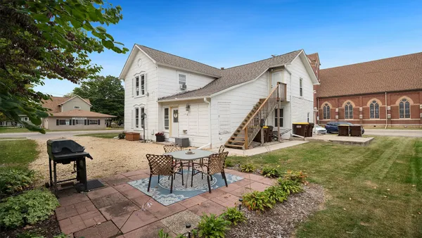 a view of a house with backyard porch and sitting area