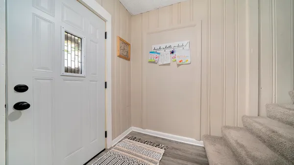 a view of an entryway with wooden floor