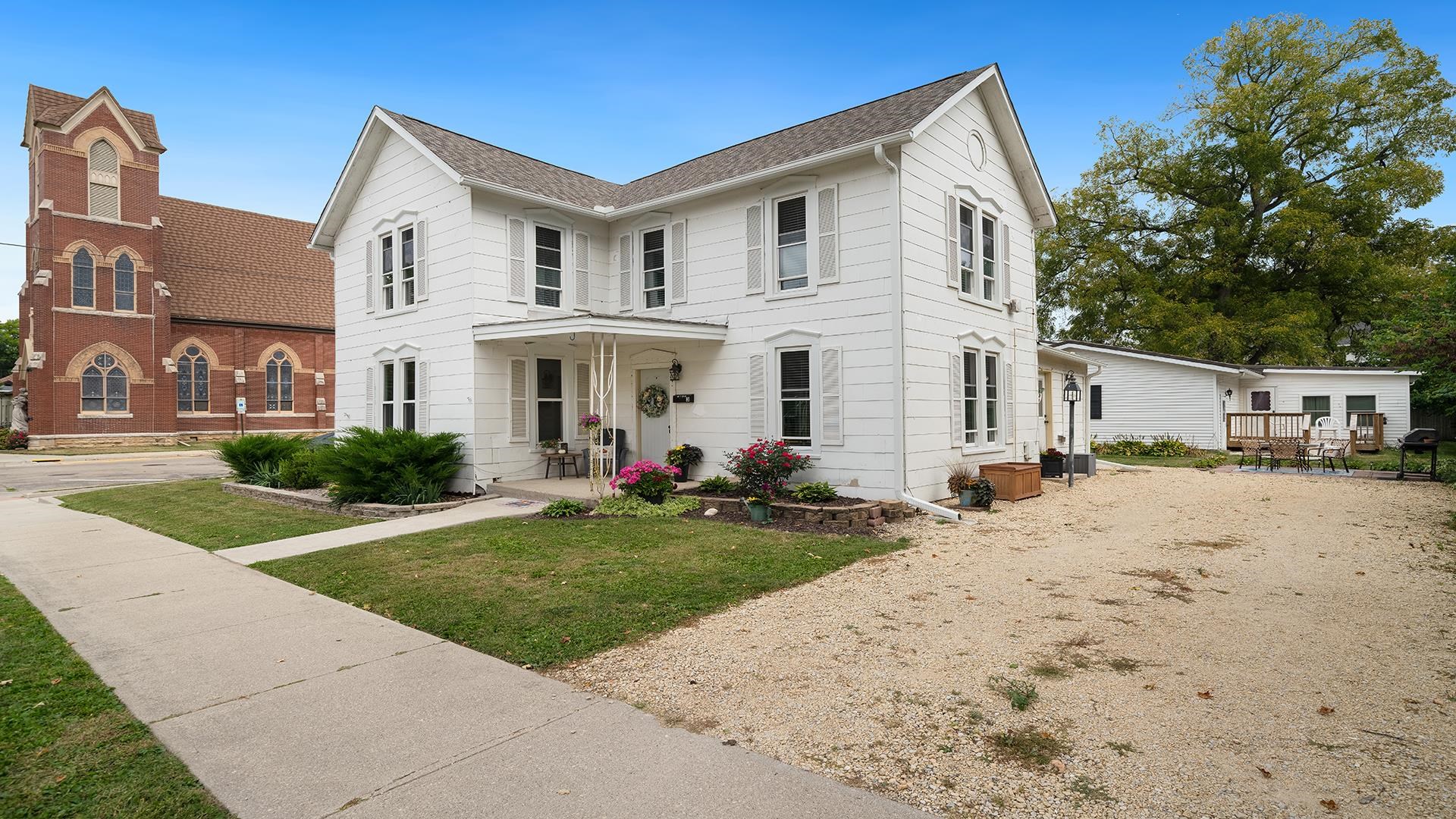 213 North 4th Street Oregon, IL 61061 - Photo 25 of 29 a view of a white house with a yard and plants