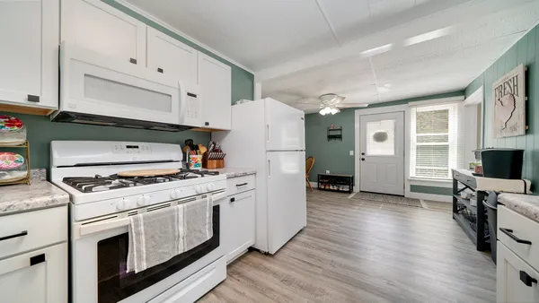 a kitchen with a stove a sink and a refrigerator