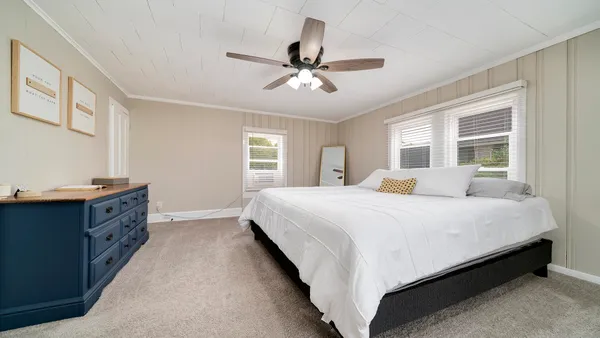 a spacious bedroom with a bed and window