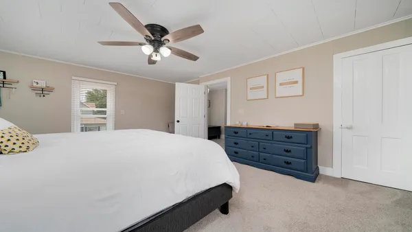 a bedroom with a bed and a dresser